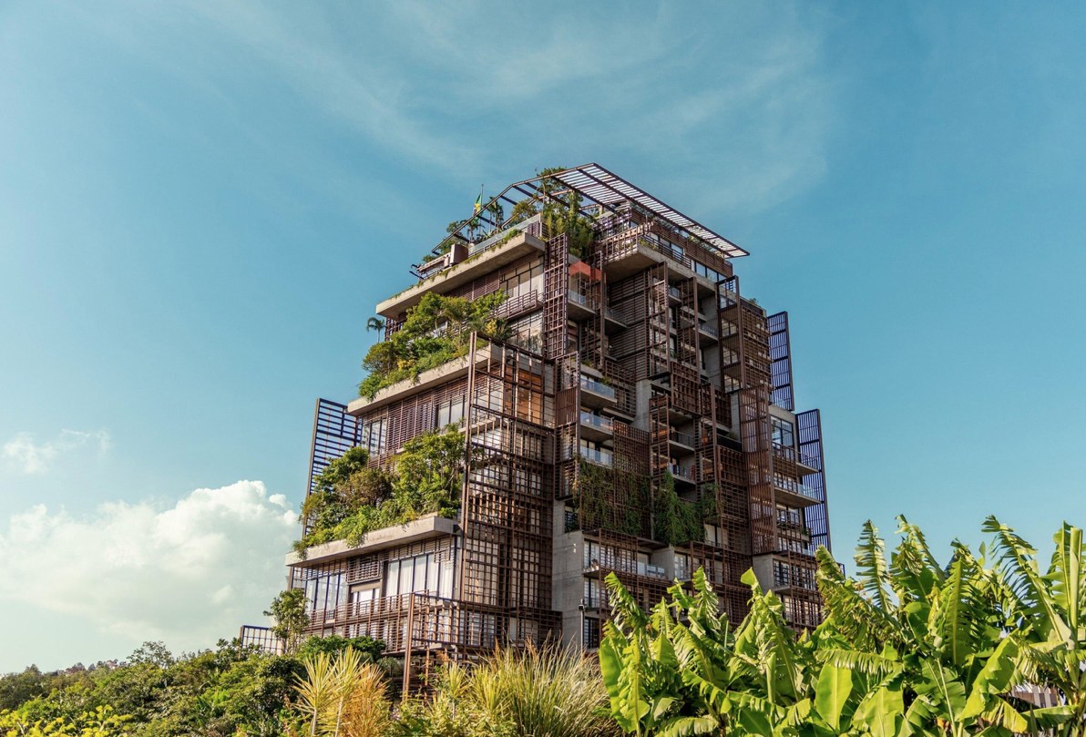 The planted facade of Rosewood São Paulo rising above tropical gardens