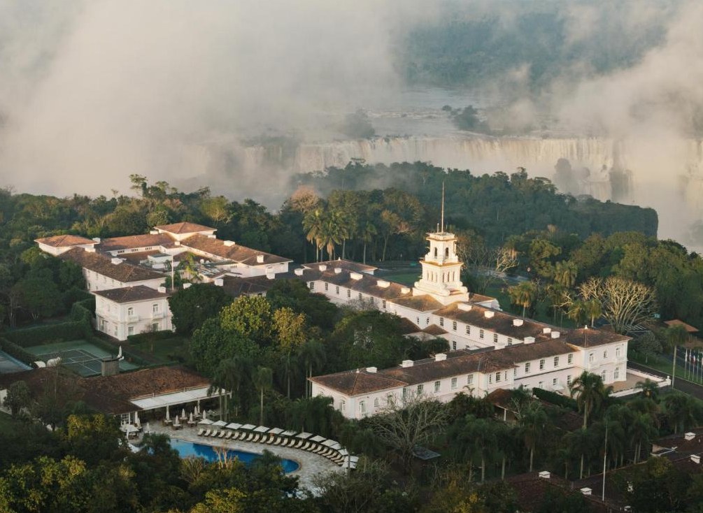Hotel das Cataratas at dawn, surrounded by rainforest with the falls beyond