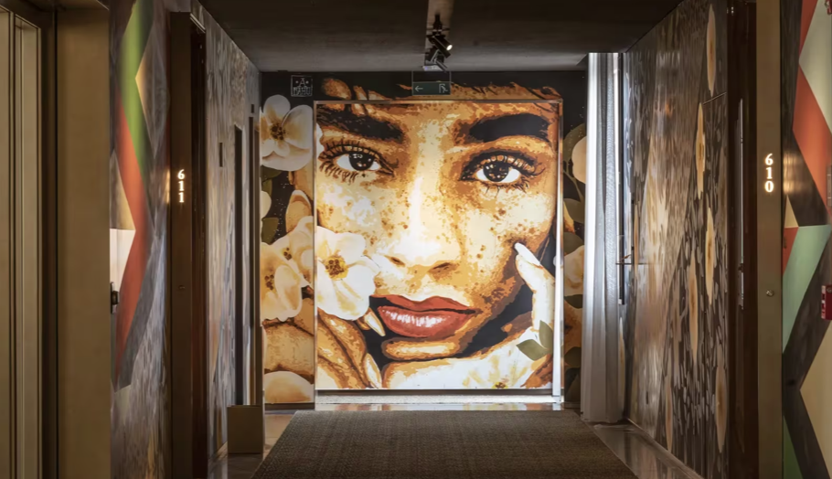 A large-scale portrait artwork in a corridor at Rosewood São Paulo